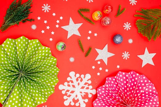Festive Christmas decorations with stars and polka dot paper fans on a vibrant red backdrop.