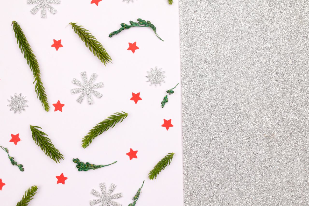 a festive christmas background featuring pine leaves snowflakes and br