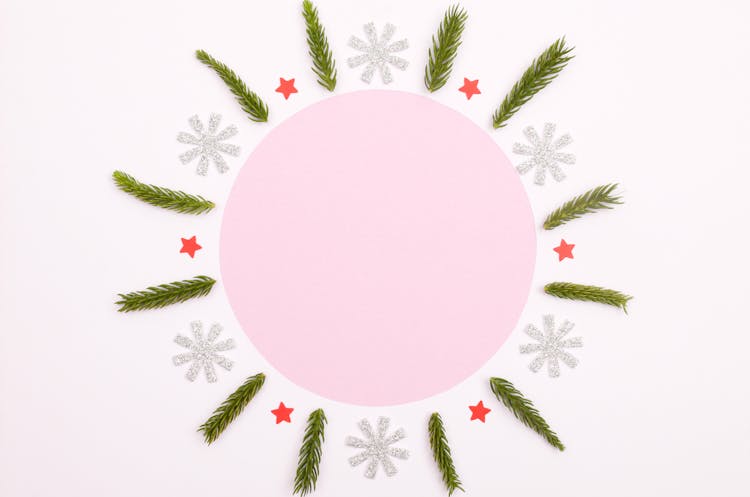 Paper Stars And Tree Branches Surrounding Pink Circle Shape