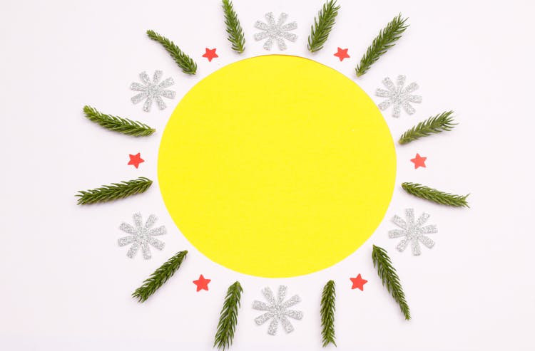 Paper Stars And Tree Branches Surrounding Yellow Circle Shape