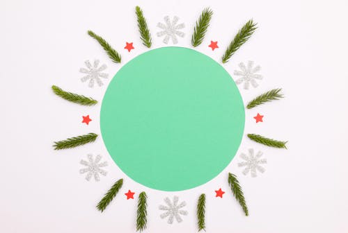 Green Circle Surrounded by Snowflakes and Stars Deisgn