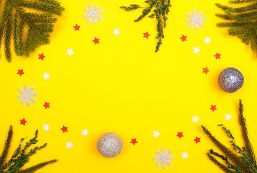 Free Cutouts and Christmas Balls on Yellow Surface Stock Photo