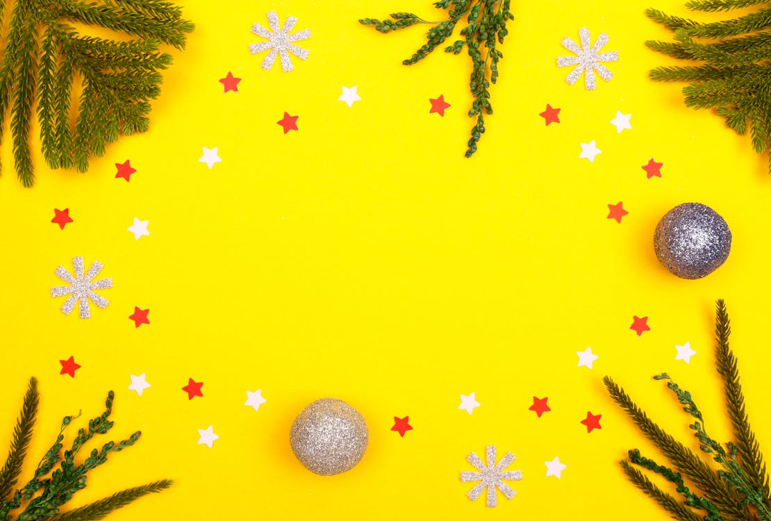 Cutouts and Christmas Balls on Yellow Surface