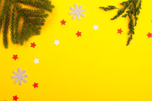 A vibrant Christmas-themed background featuring pine branches, stars, and snowflakes on a bright yellow backdrop.