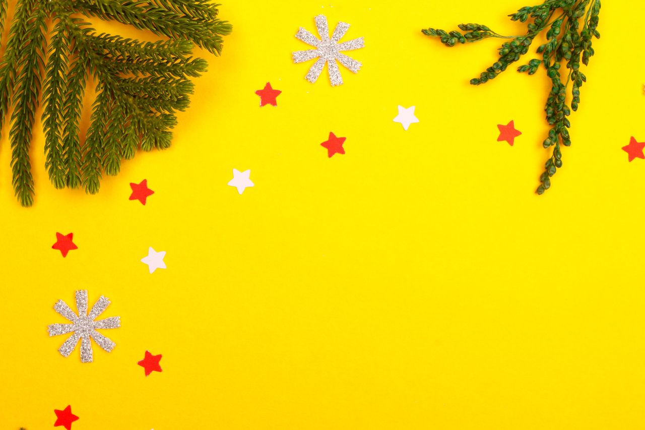 a vibrant christmas themed background featuring pine branches stars an