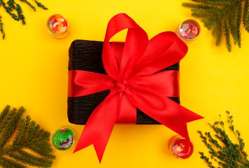 Close Up Photo of a Gift with Red Ribbon