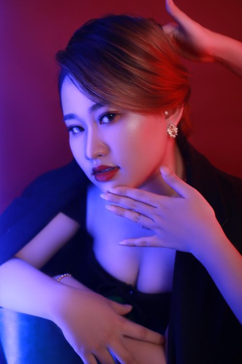 Free Glamorous portrait of an Asian woman with stylish makeup and jewelry under dramatic lighting. Stock Photo