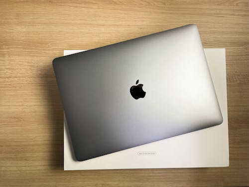 Free Silver MacBook Pro on Wooden Surface Stock Photo