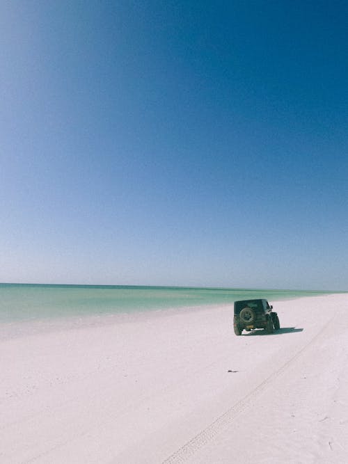 Free Vehicle Driving on the Beach Stock Photo