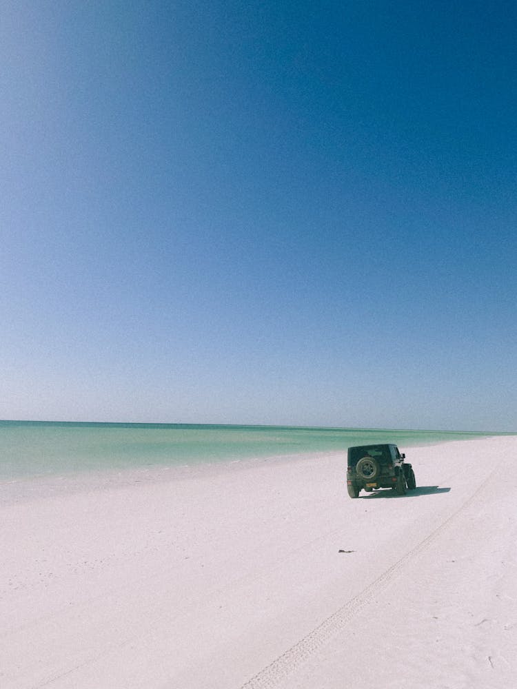 Vehicle Driving On The Beach