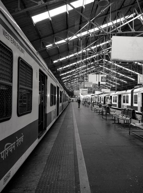 Free Black and white view of a Western Railway train station platform with trains. Stock Photo