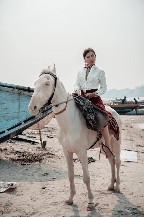 A Woman Riding a White Horse