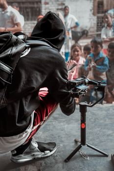 A street photographer captures vibrant street life in Varanasi, focusing on children's expressions.