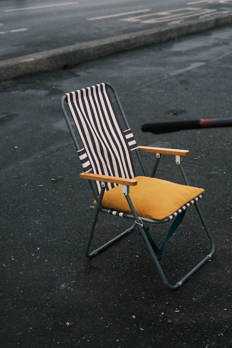 Folding Chair On A Sidewalk 