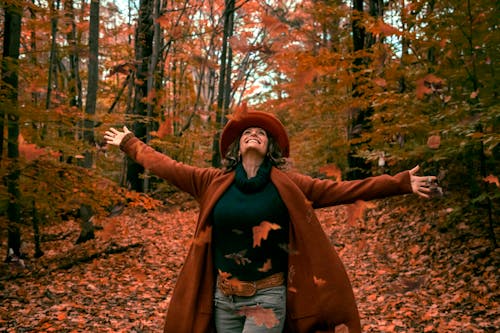 Woman in Brown Coat Walking in the Woods