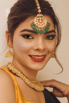 Capturing timeless beauty with traditional jewelry and a vibrant smile.