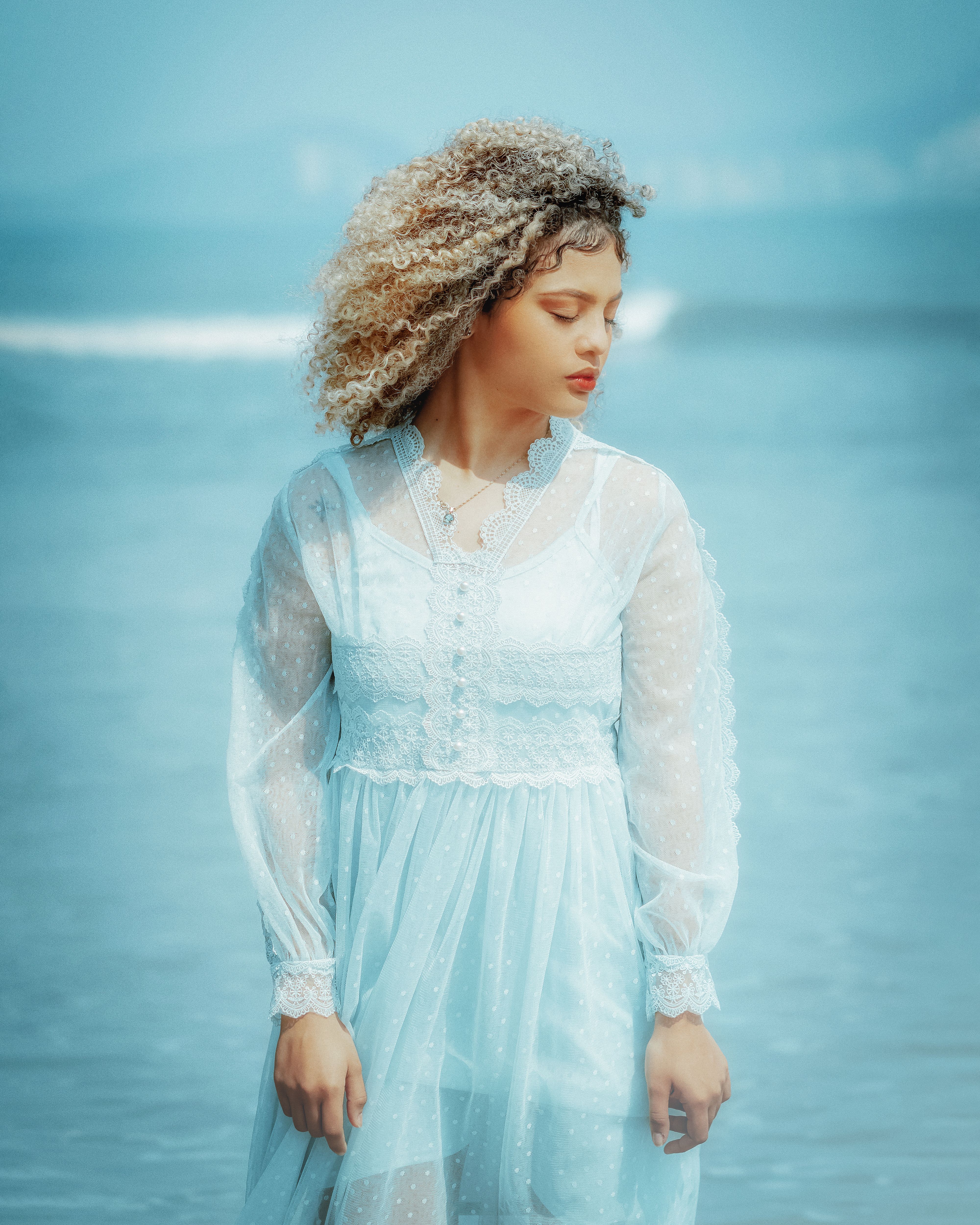Woman in Blue Lace Long Sleeve Dress Standing Near Water · Free Stock Photo