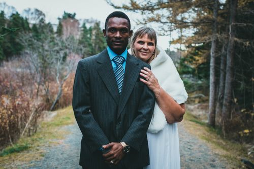 Free A newlywed couple poses in a beautiful forest during their outdoor wedding ceremony. Stock Photo