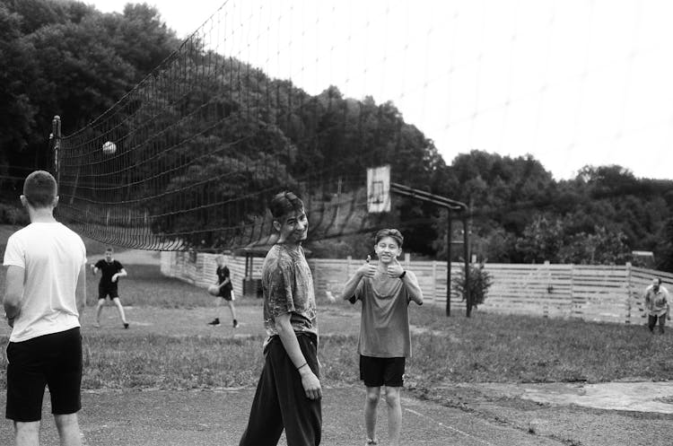 Grayscale Phot Of Boys Playing Volleyball