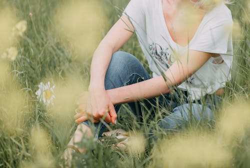 Woman Sitting on Meadow