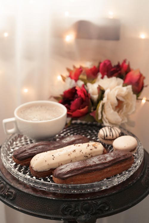 Delicious Eclairs beside a Cup of Coffee