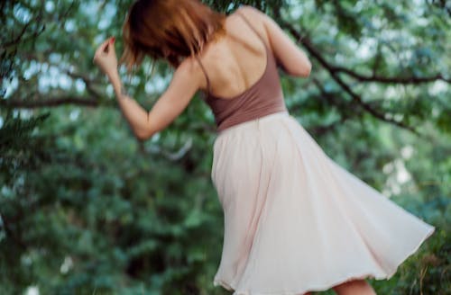 Shallow Focus of a Woman in White Skirt