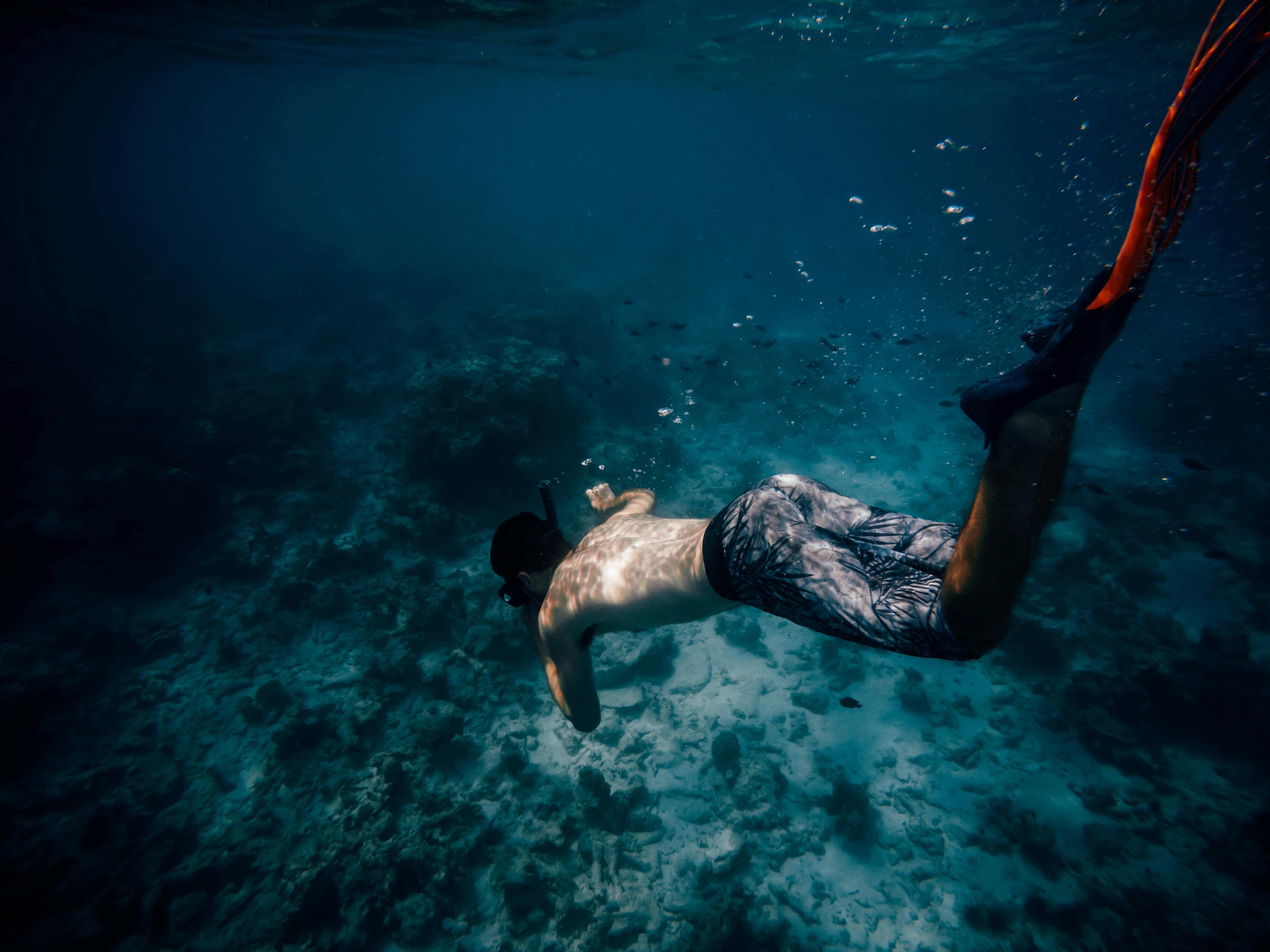 Man Freediving in Sea with Underwater Scooter · Free Stock Photo