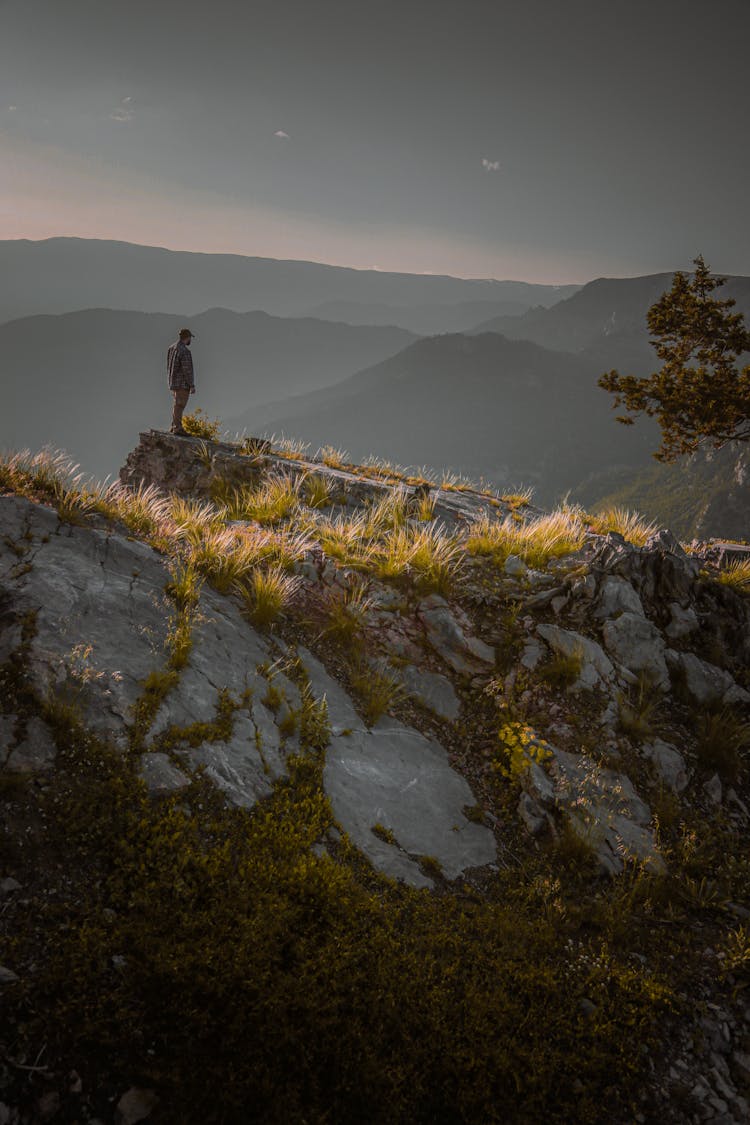 A Man Standing In Mountains