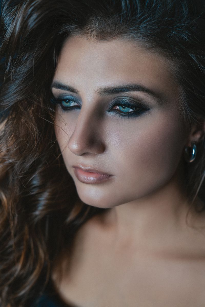 Close-up of precisely shaped brows and a soft rose-toned makeup finish