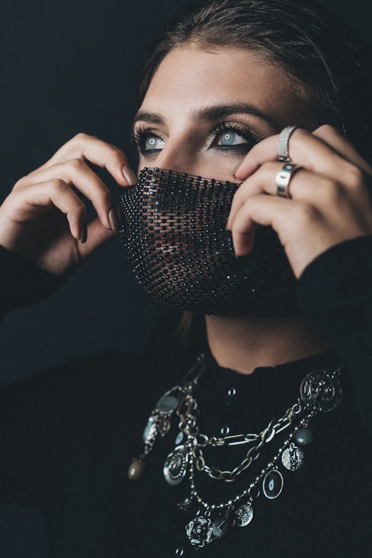 Close-Up Shot Of A Woman Wearing Her Black Facemask