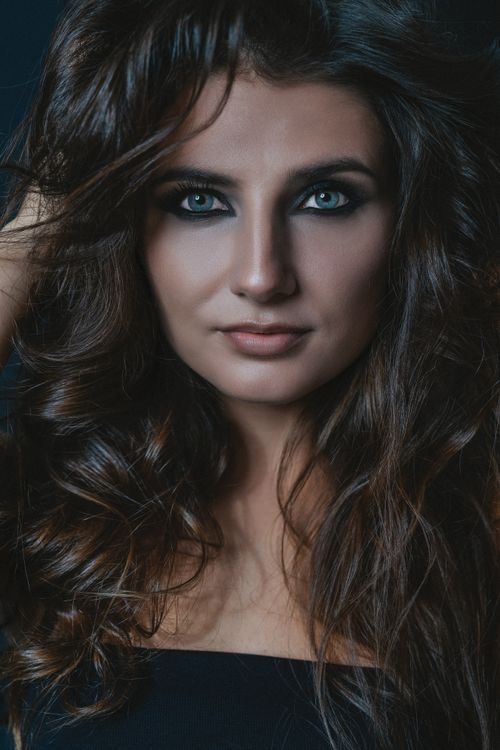 Free Close-up portrait of a beautiful woman with captivating eyes and voluminous hair Stock Photo