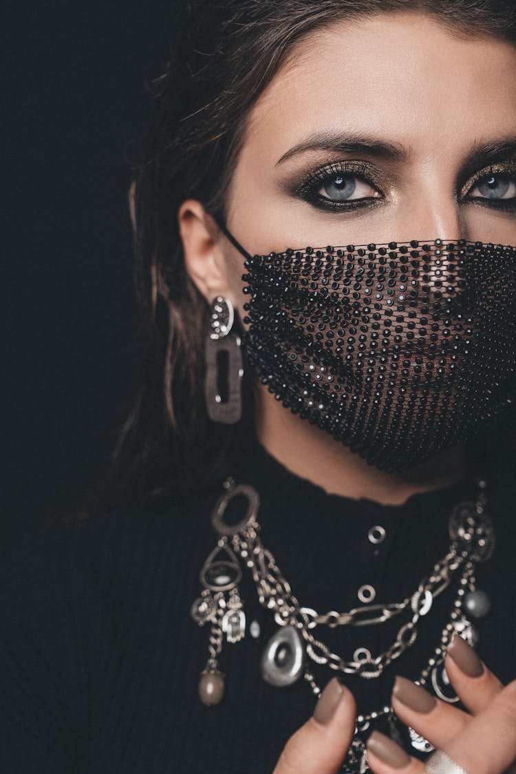 Close-Up Shot Of A Woman Wearing Her Black Facemask
