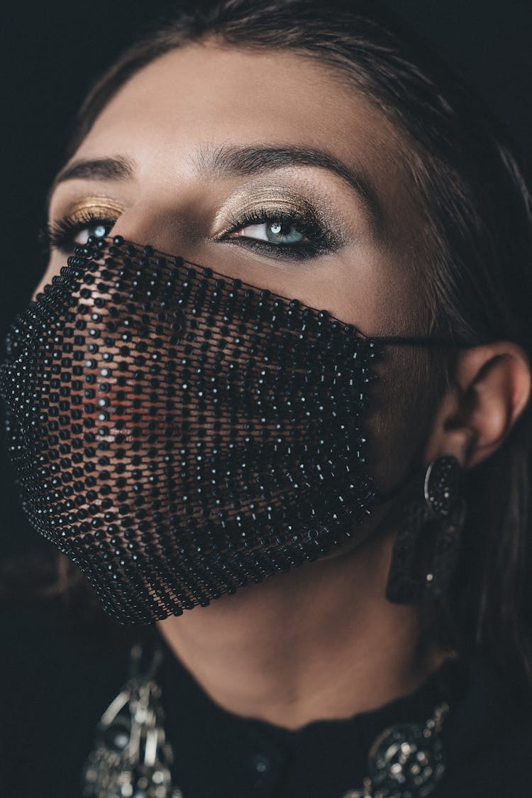 Close-Up Shot Of A Woman Wearing Her Black Facemask