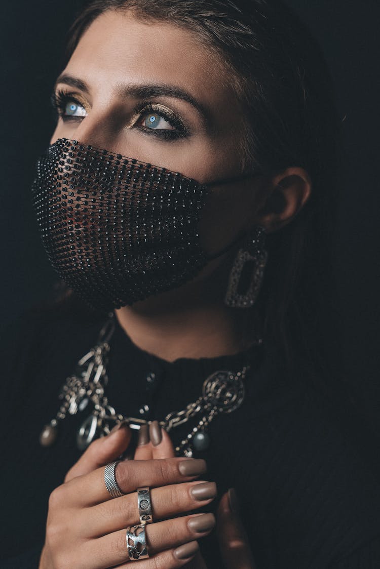 Close-Up Shot Of A Woman Wearing Her Black Facemask