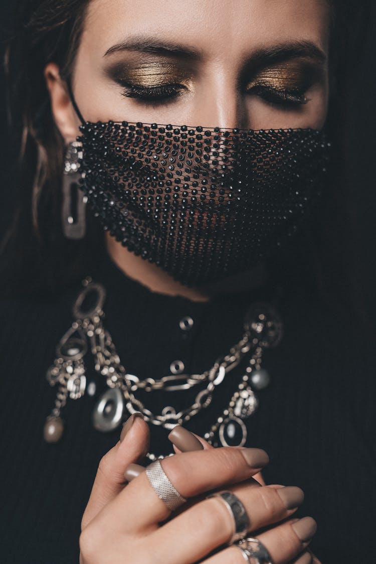 Close-Up Shot Of A Woman Wearing Her Black Facemask