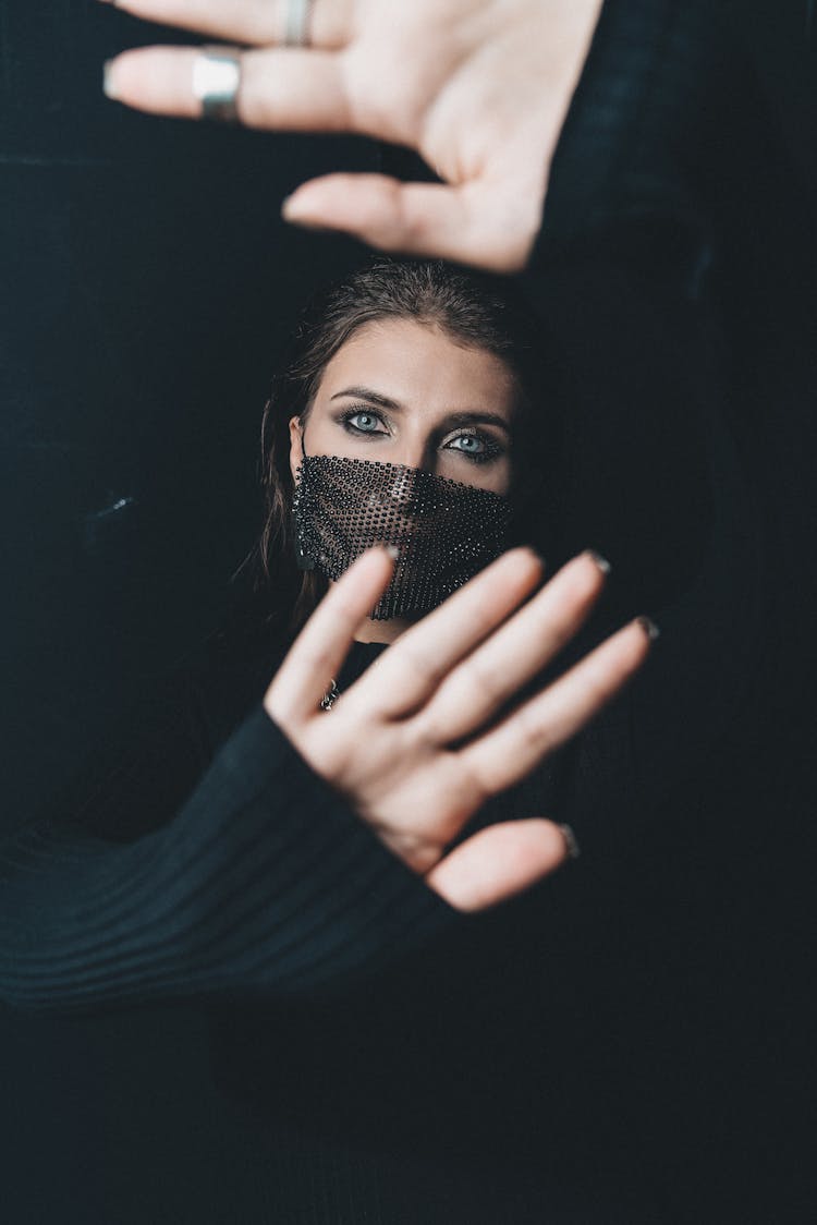 Woman In Mask And Covering Face With Hands