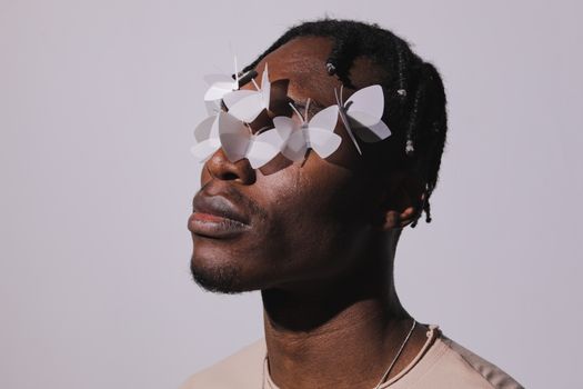 Close-Up Shot of a Man with White Butterflies on His Face