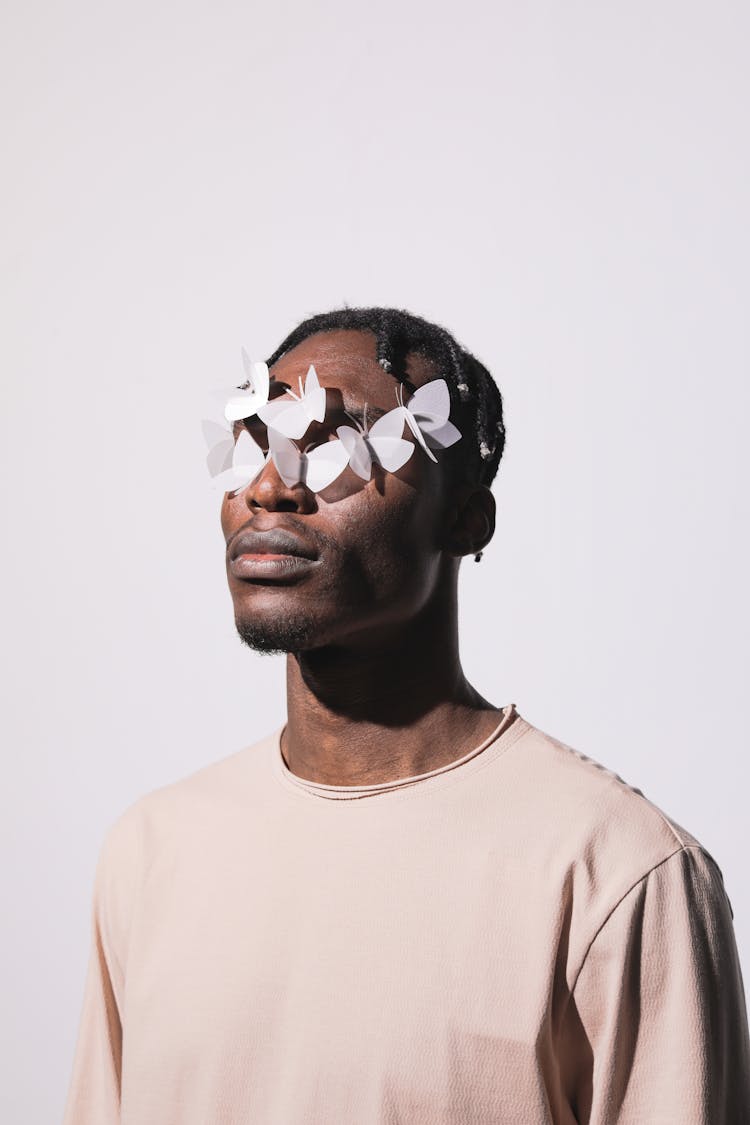 Portrait Of Man With Paper Butterflies On Face