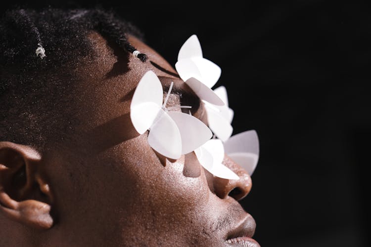 Close-Up Shot Of A Person With White Butterflies On His Face