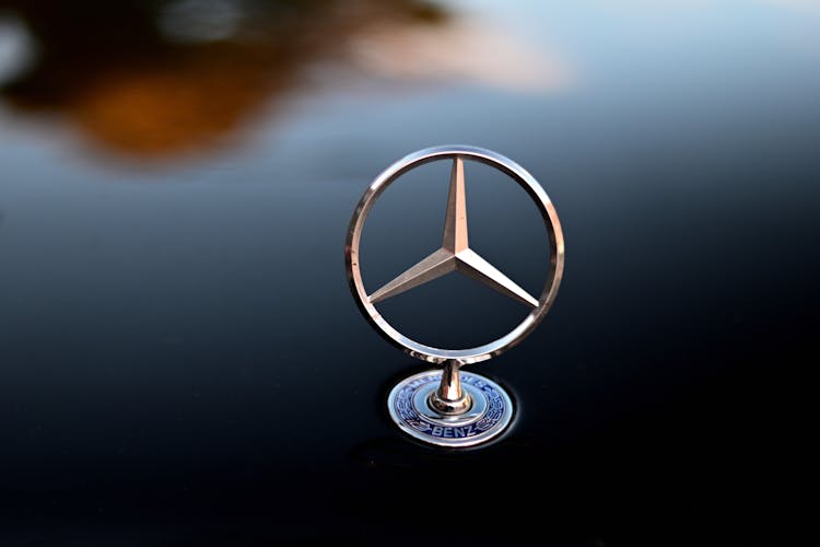 Silver Mercedes Benz Logo On Black Surface