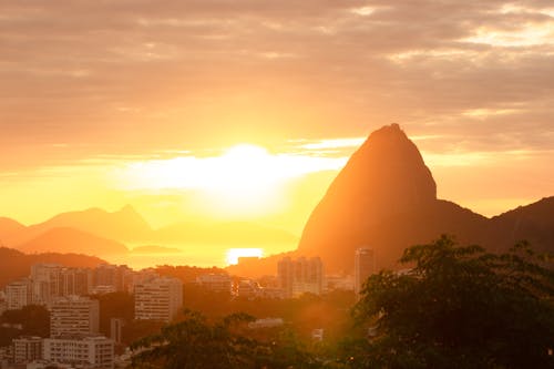 Aerial Photography of City Buildings and Mountains during Sunset