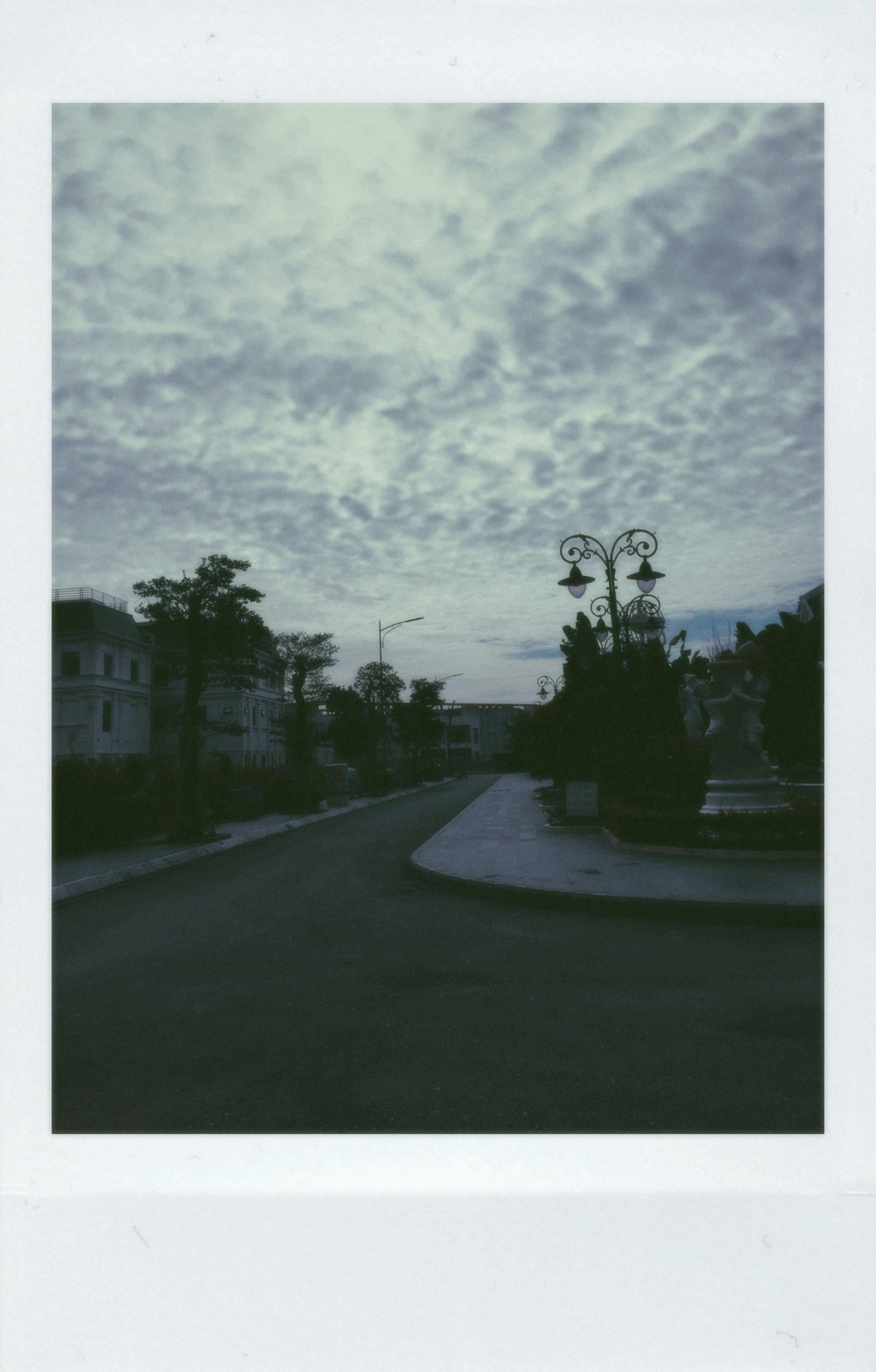 A quiet urban street captured in a vintage Polaroid style, emphasizing tranquility and nostalgia.