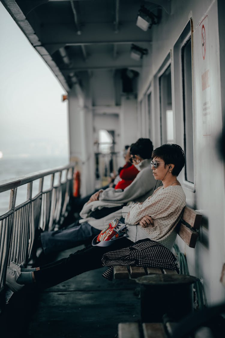 People Sitting On Bench On Ferry Board