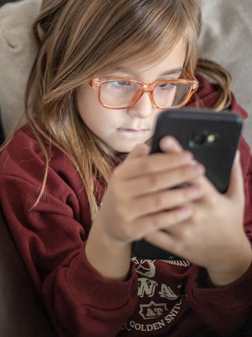 Free Young Girl Using a Smartphone Stock Photo