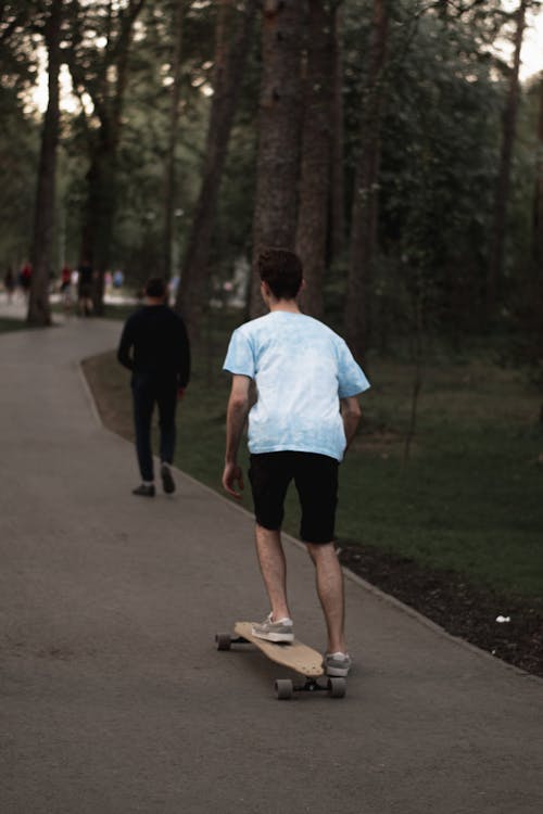 Person Skateboarding on Sidewalk