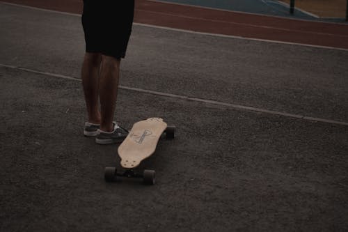 Person in Black Shorts and Sneakers Standing on the Ground