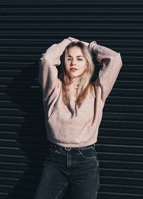 Woman Standing Beside a Black Wall