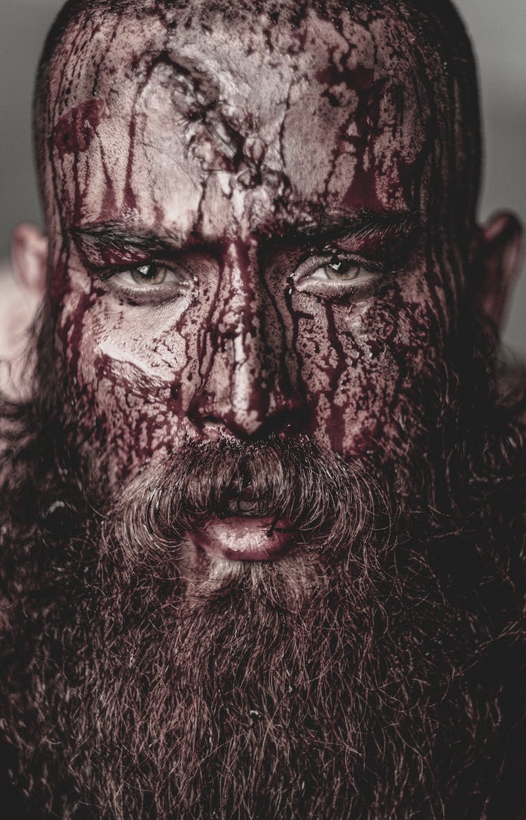 A Bearded Man With Blood On His Face