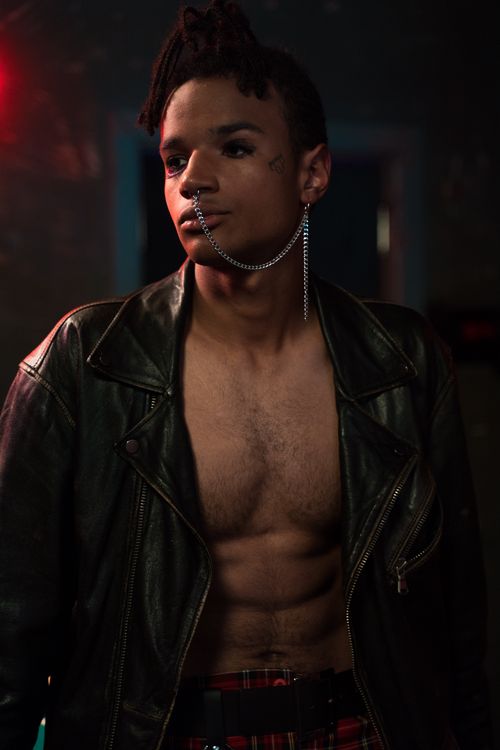 Free Portrait of a stylish young man in a black leather jacket with unique jewelry. Fashion-forward and edgy. Stock Photo