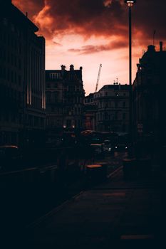 Silhouette of London's architecture under a vibrant sunset sky, capturing urban elegance.